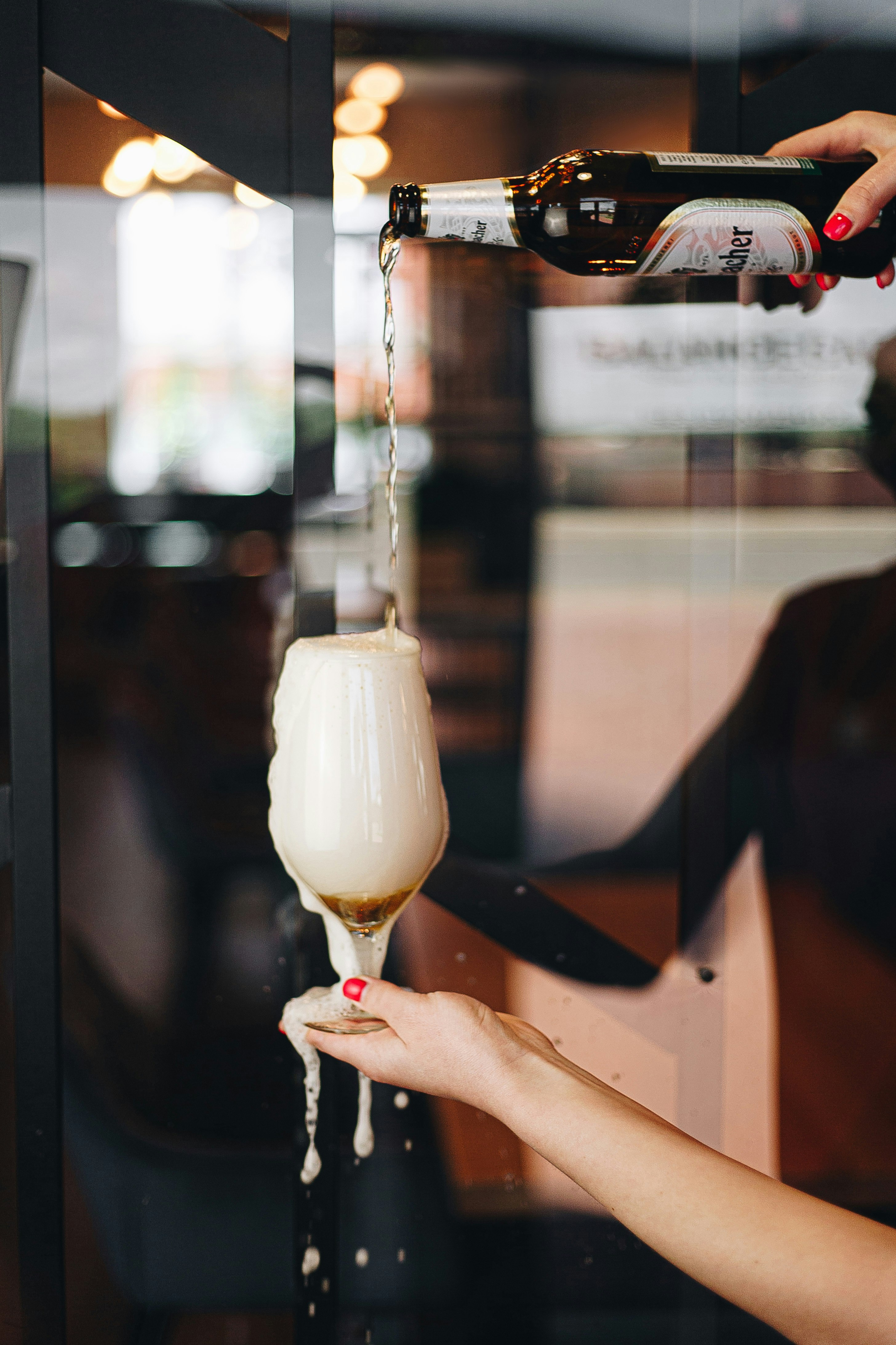 person holding clear glass cup with white liquid